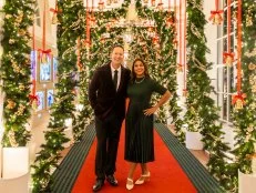 Hosts Mika and Brian Kleinschmidt pose in the East Colonnade, as seen on White House Christmas 2024.